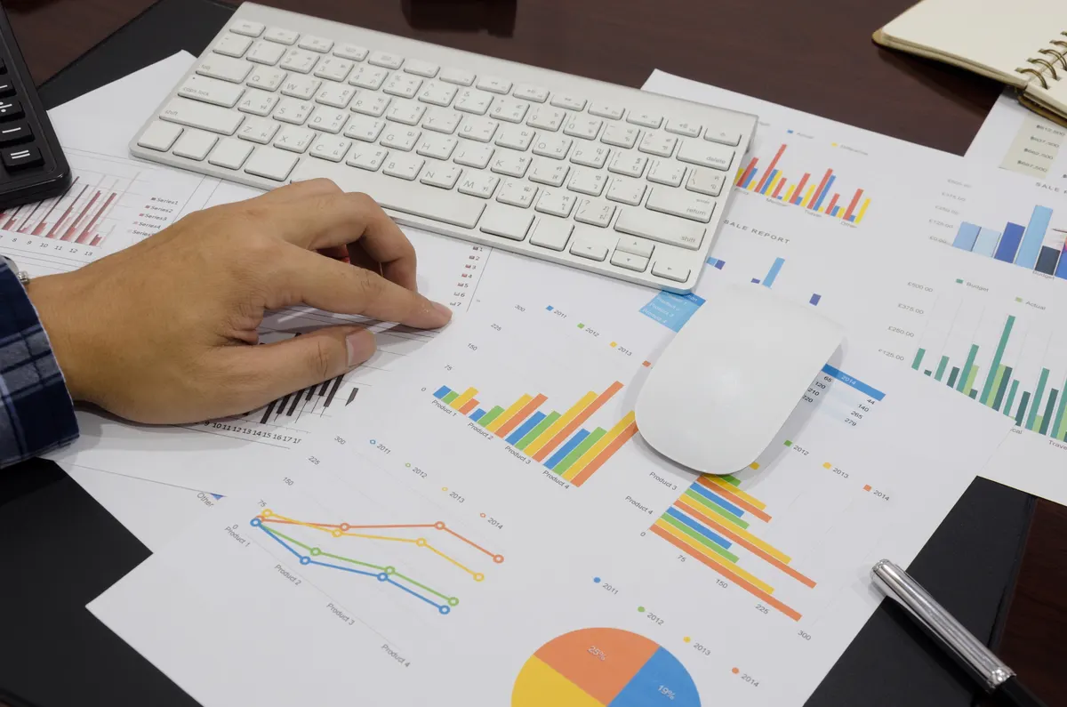 Illustrative photograph of financial reports being reviewed